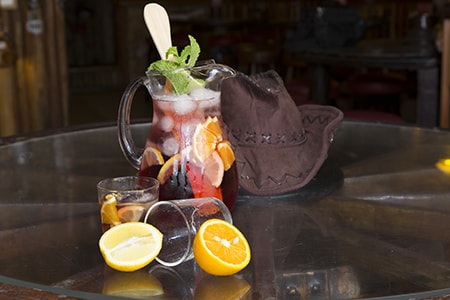 Sangria Wine decoratively placed next to Cowboy Hat
